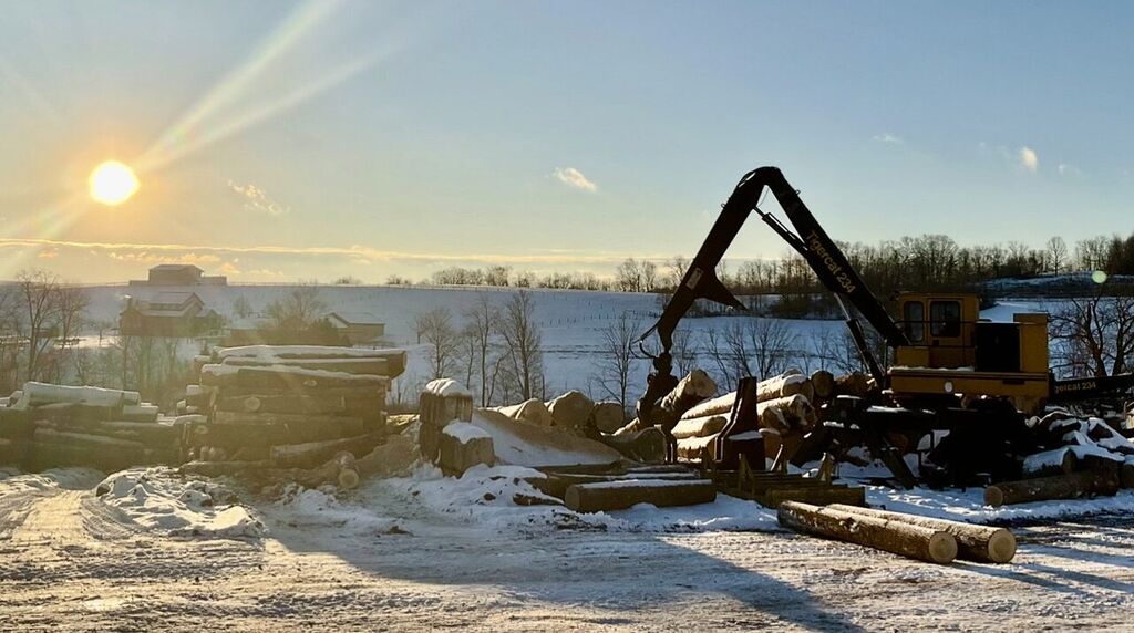 Log deck and loader at first light on a snowy Ohio farm